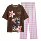 Brown t-shirt with leopard and flower design and pink checkered pants on a white background